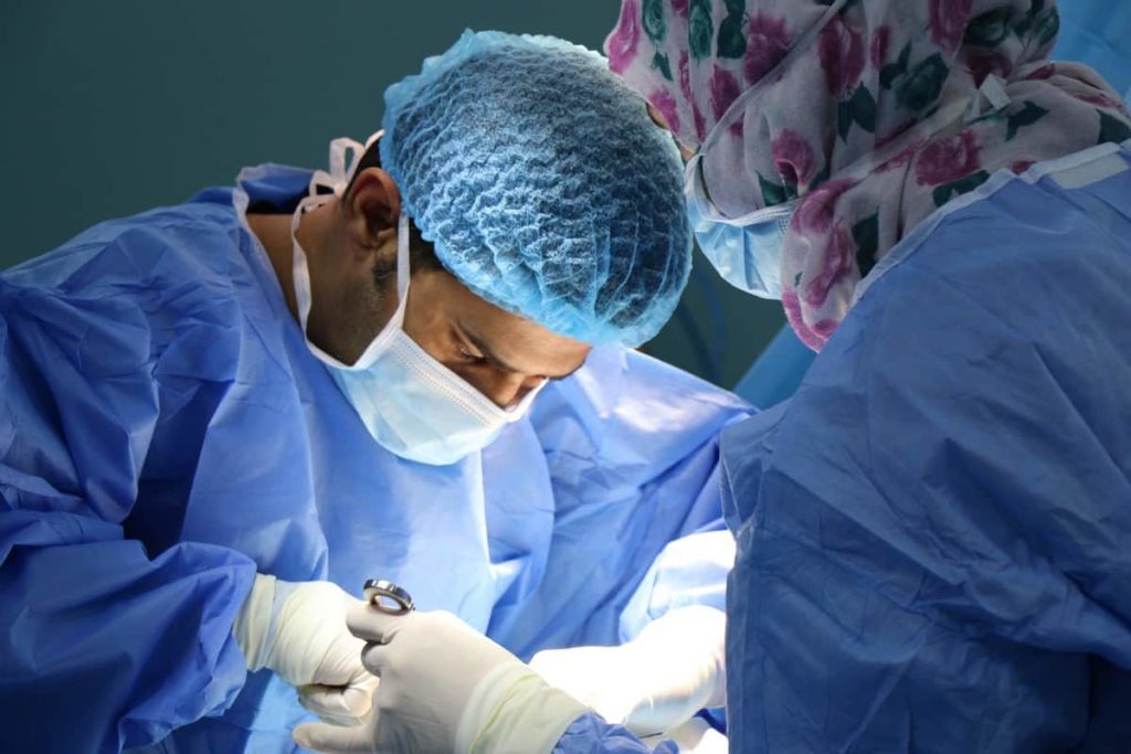 Two surgeons performing plastic surgery on a patient in Tijuana.
