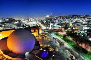 A city at night with a large ball in the middle, Tijuana.