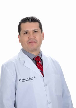 A man in a white lab coat posing for a photo in Tijuana.